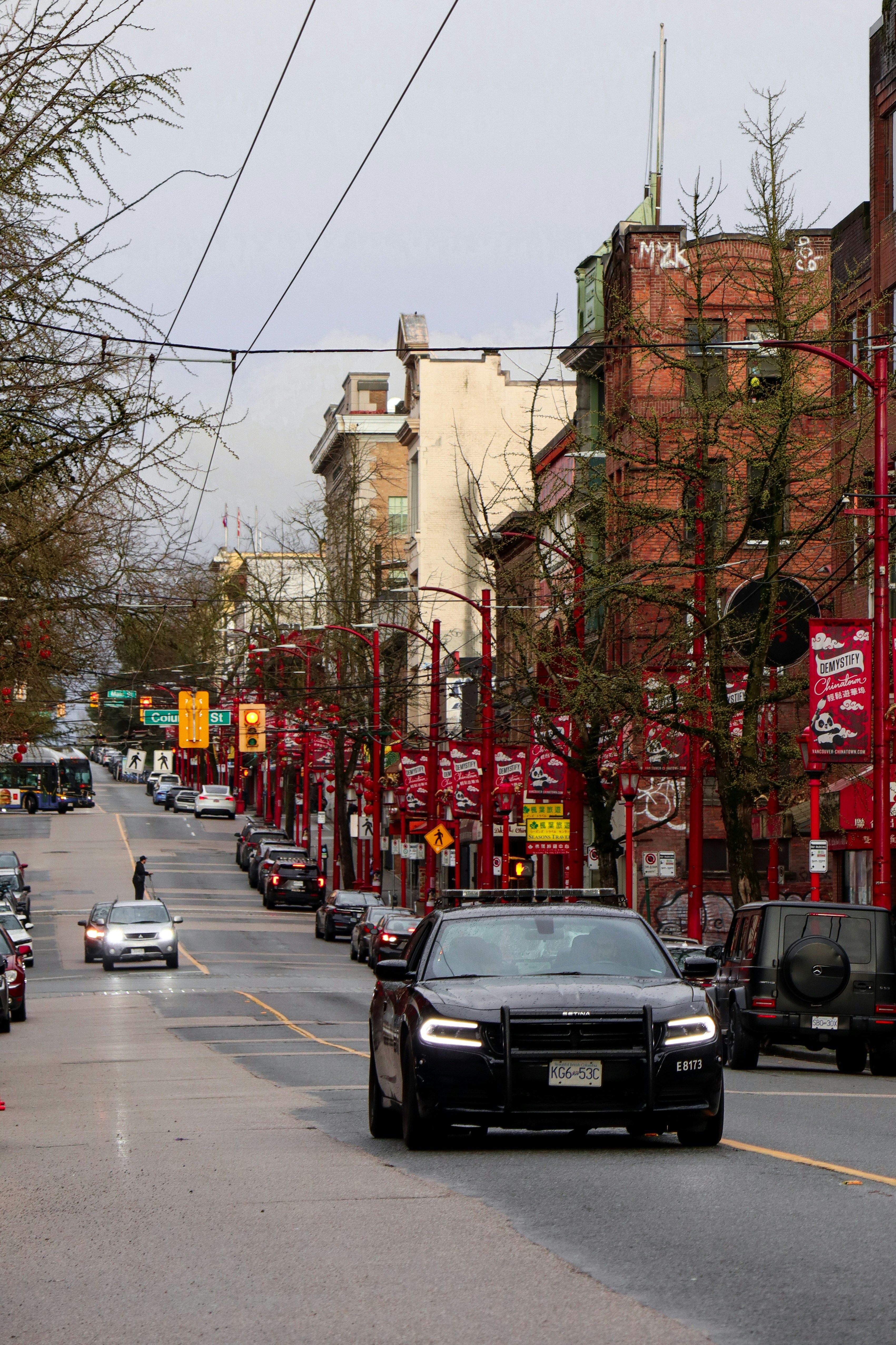 Police car driving in Chinatown district of Vancouver